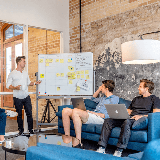 a man presenting something to his coworkers